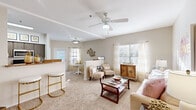 Located at 2020 Hinson Loop Rd in Little Rock, AR, this single-floor, 2-bedroom, 2-bathroom residence offers a thoughtfully designed layout that maximizes comfort and functionality. The open living room is a welcoming centerpiece, featuring plush carpet, a ceiling fan with light fixture, and multiple windows that fill the space with natural light. A half-wall partition subtly divides the living area from the adjacent dining space, creating distinct zones while maintaining an open, airy feel.

The galley-style kitchen is efficiently designed with rich, dark cabinetry, granite-look countertops, tile flooring, and a full suite of stainless steel appliances including a range, microwave, dishwasher, and refrigerator. Two well-proportioned bedrooms each feature ceiling fans, soft carpeting, and generous natural light. The primary bedroom offers a comfortable, retreat-like atmosphere, while both bedrooms are complemented by dedicated closets with built-in shelving and hanging rods for organized storage.

Both bathrooms are finished with tile flooring, dark wood vanity cabinetry, granite-look countertops, and tub-shower combinations. The overall design palette of warm neutrals and consistent finishes throughout creates a cohesive and inviting living environment.