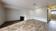 Located at 338 E 4115 S in Salt Lake City, Utah, this single-floor unit offers a clean, updated interior with a practical and comfortable layout. The main living area is bright and open, featuring durable wood-look plank flooring that extends throughout much of the space. A standout feature is the classic fireplace set against crisp white walls, adding warmth and character to the room. Large sliding glass doors dressed with vertical blinds lead to an outdoor balcony, allowing natural light to fill the space and providing views of the surrounding area. A wall-mounted climate control unit ensures year-round comfort. The kitchen is efficiently designed with white cabinetry, light granite-style countertops, a stainless steel sink, a dishwasher, and black gas range and refrigerator appliances. Wood-look flooring continues into the kitchen, maintaining a cohesive aesthetic. The bedroom features soft neutral carpet, a window with blinds for natural light, and a textured ceiling. The bathroom is well-appointed with a marble-style tub and shower surround, a white vanity with granite-look countertop, a large mirror, and matching wood-look flooring. Overall, the unit presents a fresh, move-in-ready feel with updated finishes throughout.