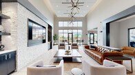 Located at 100 Seasons Blvd in West Dundee, IL, this single-floor community clubhouse delivers a polished blend of modern design and practical amenities. The grand lounge area sets the tone with soaring double-height ceilings, a dramatic sputnik chandelier, and a striking white stone accent wall hosting a large flat-screen TV. Comfortable seating arrangements, including a rich leather sofa and upholstered chairs, create an inviting gathering space, while floor-to-ceiling windows and glass doors flood the room with natural light and offer views of the outdoor area. A dedicated hallway features a built-in coffee station with subway tile backsplash and open shelving, leading to a well-appointed full kitchen. The kitchen is equipped with stainless steel appliances, a wall oven, a large white quartz island with bar seating, and a dark tray ceiling with industrial pendant lighting. An adjacent dining area with a live-edge communal table and pendant lights provides ample space for social gatherings. The fitness center is divided into distinct zones — a cardio room with treadmills, ellipticals, and large windows overlooking the pool area, plus a separate strength and equipment room. A dual-basin water station with teal mosaic tile adds a thoughtful finishing touch throughout this well-designed community facility.
