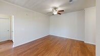 Located at 1600 Marina Rd in Irmo, South Carolina, this single-story home offers three bedrooms and three bathrooms within a well-organized floor plan. The combined kitchen and living area serves as the heart of the home, showcasing rich hardwood flooring, crown molding, and a ceiling fan with light fixture. The kitchen is equipped with stainless steel appliances, including a refrigerator, range, and built-in microwave, complemented by warm wood cabinetry, granite-style countertops, and a peninsula with pendant lighting overhead. Track lighting and a window at the sink add both function and natural light to the space.

The bedrooms feature plush carpeting, ceiling fans, and windows that bring in natural light with views of the surrounding neighborhood. Each room is served by dedicated closet space, including walk-in closets outfitted with wire shelving systems for organized storage.

The bathrooms are finished with tile flooring, wood vanities, and light countertops. One bathroom includes a soaking tub with tiled surround, adding a comfortable amenity. Two hallways connect the rooms efficiently throughout the single-level layout, contributing to an overall functional and cohesive living environment.