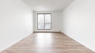Located at 1280 Webster St in London, Ontario, this well-appointed 1-bedroom, 1-bathroom unit offers a clean, modern aesthetic across a single floor. The open-concept living and kitchen area creates a bright, airy atmosphere, anchored by warm hardwood-style flooring that runs throughout the space. The kitchen is equipped with stainless steel appliances — including a refrigerator, stove, and microwave — white cabinetry, and a peninsula with a built-in sink, providing both additional prep space and a casual dining option. The living area is generously sized, with crisp white walls and natural light from nearby windows that enhance the sense of openness. The spacious primary bedroom features a large sliding window that invites natural light and outdoor views, a textured ceiling, and baseboard heating, offering a comfortable and functional retreat. A dedicated closet provides convenient storage. The bathroom is finished in a clean, all-white palette with marble-look tile flooring, a full soaker tub with shower, and modern fixtures. The overall design of the unit is minimal and refreshed, making it a functional and inviting living space.