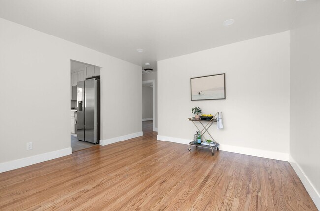 view of living room into kitchen which leads to the outside and master - 9211 Earl St