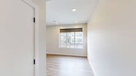 Located in the vibrant Seton community of Calgary, this two-storey townhome offers a well-designed layout across two floors. The main level features a sleek, modern kitchen outfitted with white cabinetry, a dark subway tile backsplash, stainless steel appliances, a large island with an undermount sink, and pendant lighting. Light hardwood-style flooring flows throughout, complementing the bright, neutral palette. A door off the kitchen leads directly to a private balcony, offering views of the surrounding community and open prairie landscape beyond. A convenient half-bath powder room completes the main level. Upstairs, two bedrooms provide comfortable retreats, each with large windows that invite natural light and include built-in closets with sliding doors. The generously sized primary bedroom features its own ensuite bathroom, finished with a glass-enclosed shower, vessel sink, and modern black hardware accents. A full bathroom with a soaker tub serves the second bedroom and hallway. Three bathrooms in total ensure practicality for residents and guests alike. The clean, contemporary aesthetic is carried consistently throughout the home, making it an efficient and stylish space in one of Calgary's newest planned communities.