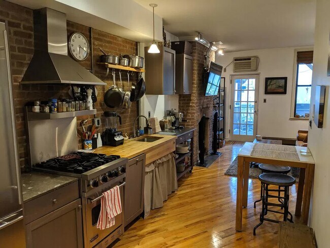 Furnished view of kitchen, facing porch and living room - 128 Sussex St