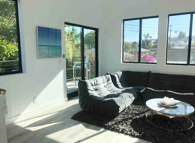 Living room with entrance to balcony via sliding door. - 6952 W 77th St