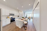 Located at 2718 N 118th St in Omaha, Nebraska, this well-appointed single-floor residence offers a thoughtfully designed layout with one bedroom, two bathrooms, and a dedicated office space. The open-concept kitchen and living area serves as the heart of the home, featuring crisp white cabinetry extending to the ceiling, stainless steel appliances, and a generous island with bar seating — ideal for both meal preparation and casual dining. Rich wood-look flooring runs throughout the main living areas, complementing the bright, airy atmosphere created by recessed lighting and an abundance of natural light. The living room provides a comfortable and spacious retreat, with large windows that invite outdoor views. The bedroom is a calm, carpeted space with a large window that fills the room with natural light. The dedicated office includes direct access to the outdoors through a glass door flanked by expansive windows, creating a bright and productive workspace. Two well-appointed bathrooms, each with white vanity cabinetry and clean finishes, complete the layout. Throughout the residence, a neutral color palette and modern design details create a cohesive, move-in-ready environment.