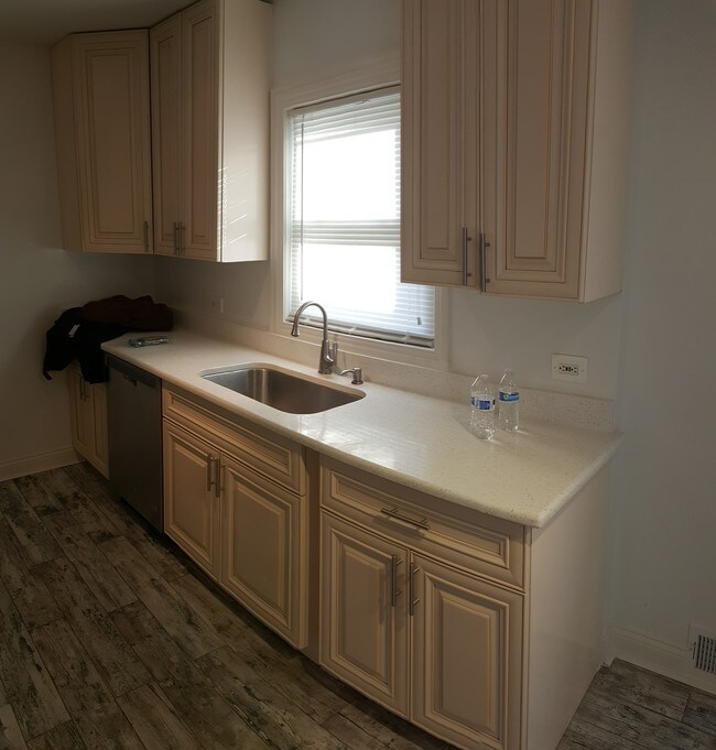 Kitchen with Stainless steel appliances which includes a side by side ref microwav with dishwasher - 900 Dunlop Ave Apartments