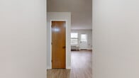 Located at 200 E Webster St in Nashville, TN, this two-bedroom, one-bathroom unit offers a practical and well-organized single-floor layout. The living room serves as the welcoming heart of the home, featuring light wood-look flooring, neutral walls, a textured ceiling, and a white entry door flanked by windows fitted with blinds that allow for ample natural light. A wall-unit HVAC system provides climate control throughout.

The kitchen is efficiently designed with gray cabinetry, a white countertop, a stainless steel dishwasher, a gas range, and a refrigerator. Stone-tile flooring anchors the kitchen space, which transitions seamlessly into the living area.

Both bedrooms feature plush carpet flooring and windows with outdoor views. The primary bedroom includes a closet with built-in shelving for organized storage, while each room benefits from a wall-unit HVAC system. The neutral color palette throughout keeps the space feeling bright and open.

The full bathroom is thoughtfully appointed with a tub/shower combo, grab bars for accessibility, a gray vanity with a white countertop, and wood-look flooring. The overall design is clean, functional, and move-in ready, offering a comfortable living environment in Nashville.