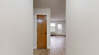 Located at 200 E Webster St in Nashville, TN, this two-bedroom, one-bathroom unit offers a practical and well-organized single-floor layout. The living room serves as the welcoming heart of the home, featuring light wood-look flooring, neutral walls, a textured ceiling, and a white entry door flanked by windows fitted with blinds that allow for ample natural light. A wall-unit HVAC system provides climate control throughout.

The kitchen is efficiently designed with gray cabinetry, a white countertop, a stainless steel dishwasher, a gas range, and a refrigerator. Stone-tile flooring anchors the kitchen space, which transitions seamlessly into the living area.

Both bedrooms feature plush carpet flooring and windows with outdoor views. The primary bedroom includes a closet with built-in shelving for organized storage, while each room benefits from a wall-unit HVAC system. The neutral color palette throughout keeps the space feeling bright and open.

The full bathroom is thoughtfully appointed with a tub/shower combo, grab bars for accessibility, a gray vanity with a white countertop, and wood-look flooring. The overall design is clean, functional, and move-in ready, offering a comfortable living environment in Nashville.