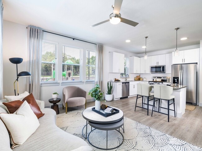 Indulge your culinary passions in style at Modera Georgetown's gourmet kitchen, featuring granite countertops, sleek shaker white cabinetry with satin pulls, and elegant under-cabinet lighting. - Modera Georgetown