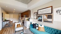 Located in the heart of Durham, NC, this contemporary residence at 509 N Mangum St showcases a thoughtfully designed single-floor layout that seamlessly blends modern industrial aesthetics with refined comfort. The open-concept living, dining, and kitchen area is anchored by striking exposed concrete ceiling panels, light wood-style flooring, and recessed lighting that create a warm yet sophisticated ambiance. The kitchen features stainless steel appliances, warm wood cabinetry, light countertops, and a classic subway tile backsplash, offering both style and functionality. The living area opens directly onto a private balcony through full-height glass doors, flooding the space with natural light and providing outdoor views of the surrounding urban landscape. The bedroom is a serene retreat, featuring a soaring upholstered headboard, exposed concrete ceiling accents, and large windows that invite abundant natural light. The en-suite bathroom is finished with a white vanity, modern fixtures, and a glass-enclosed walk-in shower, complemented by a spacious walk-in closet with built-in shelving and hanging rods. A dedicated entryway provides a clean transition into the home. Every detail reflects a commitment to contemporary urban living.
