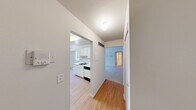 Located at 7127 Bonnie Dr W in Westland, Michigan, this single-floor, one-bedroom, one-bathroom home offers a practical and well-organized layout. The living room is bright and welcoming, featuring plush carpet flooring, neutral white walls, and multiple windows with vertical blinds that allow generous natural light to fill the space. The kitchen is efficiently designed with white cabinetry lining both sides, light wood-style flooring, a gas range, dishwasher, refrigerator, and a single-basin sink. A ceiling fan with a light fixture and additional windows provide both ventilation and natural light, making the kitchen and adjacent dining area feel open and airy. The bedroom offers comfortable carpeted flooring, neutral tones, and a double bi-fold closet for ample storage. The full bathroom includes a tiled shower-tub combination with classic white square tile surround. A hallway connects the rooms, contributing to the home's efficient flow. Throughout the home, the clean, neutral palette and consistent finishes create a cohesive and move-in ready environment suitable for a variety of lifestyles.