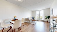 Located at 101 Boul Sacré-Coeur in Gatineau, QC, this two-bedroom, one-bathroom unit offers a bright and functional layout across a single floor. Light wood flooring runs throughout, creating a cohesive and clean aesthetic in every room.

The combined living and dining area serves as the heart of the unit, bathed in natural light from a large sliding glass door that opens to a balcony with views of the surrounding neighbourhood. The open layout comfortably accommodates both a dining set and a living seating arrangement.

The kitchen is efficiently designed with white cabinetry, ample upper and lower storage, wood-toned countertops, and a range — offering all essential cooking amenities in a compact, well-organized space.

Both bedrooms feature the same warm wood flooring and crisp white walls. The primary bedroom benefits from direct access to a balcony and generous natural light, while the second bedroom includes a sliding-door closet for convenient storage. An additional closet elsewhere in the unit provides further organizational space.

The bathroom is cleanly finished with a shower/tub combination, white cabinetry, and wood flooring. Throughout the unit, the neutral palette, consistent flooring, and abundant natural light contribute to a bright, calm, and welcoming atmosphere.