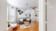 Located at 1900 Westview Blvd in Conroe, TX, this well-appointed 2-bedroom, 2-bathroom single-story home offers a cohesive and comfortable layout. Warm hardwood flooring flows throughout the main living areas, complemented by neutral tones and abundant natural light from well-placed windows. The inviting living room features a ceiling fan and built-in shelving, seamlessly connecting to the dining area, which is defined by wainscoting details and an elegant arched passage. The kitchen is equipped with rich wood cabinetry, granite-style countertops, and black appliances, with a convenient pass-through opening to the living space. The primary bedroom offers plush carpet, a ceiling fan, dedicated built-in shelving, and direct access to a private ensuite bathroom and walk-in closet. The second bedroom is equally comfortable, with soft carpet and a bright window. Both bathrooms feature warm wood vanities with granite countertops and tile flooring, with the primary bath offering a soaking tub. A private balcony off the entrance provides a pleasant outdoor retreat surrounded by lush trees. The home also includes a dedicated entrance, hallway, and two closets, rounding out this thoughtfully designed living space.