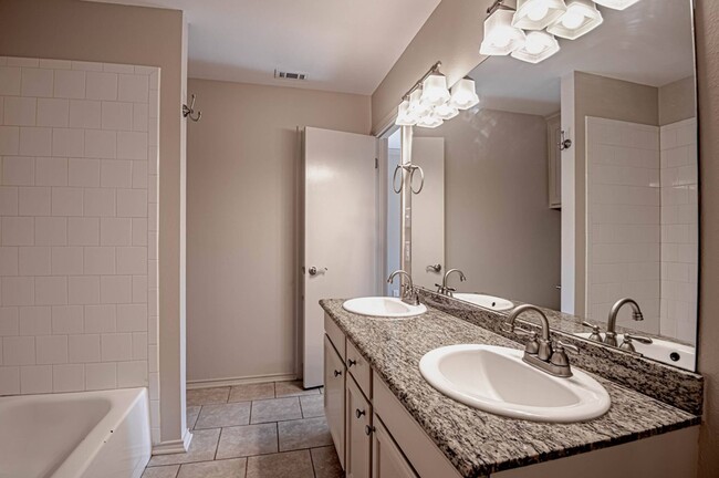 Bathroom with double vanity - Dogwood Village Apartments