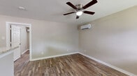 Located at 4706 Yellowstone Blvd in Houston, TX, this well-designed one-bedroom, one-bathroom unit offers a practical and comfortable single-floor layout. Rich, wood-style plank flooring runs throughout the entire space, lending warmth and continuity to every room.

The living room is a bright, open area equipped with a ceiling fan and a wall-mounted mini-split HVAC unit for efficient climate control. Neutral-toned walls provide a clean, versatile backdrop. The kitchen is a standout feature, showcasing white shaker cabinetry, striking granite countertops, a stainless steel range, and a full-size refrigerator. Multiple windows allow natural light to fill the space, creating an inviting atmosphere.

The bedroom offers a comfortable footprint, complete with a ceiling fan, a wall-mounted mini-split unit, a horizontal window for natural light, and a double sliding-door closet for ample storage. Additional closet space is available elsewhere in the unit, adding to overall storage convenience.

The bathroom is finished with a bold, stone-look tiled tub and shower surround featuring a built-in niche, complemented by a clean white tub and toilet. The unit's cohesive design, modern finishes, and functional layout make it a practical choice in the Houston area.
