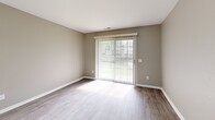 Located at 22700 Civic Center Dr in Southfield, MI, this well-designed 2-bedroom, 2-bathroom residence offers a comfortable and functional single-floor layout. The open-concept living and kitchen area serves as the heart of the home, where a peninsula with light granite countertops separates the two spaces. The kitchen is outfitted with white cabinetry, a tile backsplash, stainless steel appliances including a refrigerator, range, and microwave, and pendant lighting that adds a modern touch. Wood-look plank flooring runs throughout the entire unit, complemented by neutral taupe-toned walls and crisp white trim. The living room features a sliding glass door dressed with vertical blinds, allowing natural light to fill the space and providing outdoor access. The primary bedroom offers generous proportions with a large bi-fold closet and natural light from a sizable window. The second bedroom also includes bi-fold closet storage. Two bathrooms serve the home — one featuring a clean walk-in shower, and the other a full soaking tub and shower combo with a curved rod. The consistent finishes and neutral palette throughout create a cohesive, move-in-ready environment.