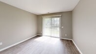 Located at 22700 Civic Center Dr in Southfield, MI, this well-designed 2-bedroom, 2-bathroom residence offers a comfortable and functional single-floor layout. The open-concept living and kitchen area serves as the heart of the home, where a peninsula with light granite countertops separates the two spaces. The kitchen is outfitted with white cabinetry, a tile backsplash, stainless steel appliances including a refrigerator, range, and microwave, and pendant lighting that adds a modern touch. Wood-look plank flooring runs throughout the entire unit, complemented by neutral taupe-toned walls and crisp white trim. The living room features a sliding glass door dressed with vertical blinds, allowing natural light to fill the space and providing outdoor access. The primary bedroom offers generous proportions with a large bi-fold closet and natural light from a sizable window. The second bedroom also includes bi-fold closet storage. Two bathrooms serve the home — one featuring a clean walk-in shower, and the other a full soaking tub and shower combo with a curved rod. The consistent finishes and neutral palette throughout create a cohesive, move-in-ready environment.