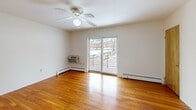 Located at 321 Crowells Rd in Highland Park, NJ, this 2-bedroom, 1-bathroom residence offers a well-organized single-floor layout designed for comfortable everyday living. Warm-toned hardwood floors flow throughout the main living areas and both bedrooms, lending a cohesive and inviting character to the space.

The combined kitchen and living room area anchors the layout. The kitchen is equipped with stainless steel appliances — including a gas range, built-in microwave, and dishwasher — complemented by warm wood cabinetry, dark granite-style countertops, and classic white tile backsplash. A window above the sink brings in natural light. A pass-through window connects the kitchen to the living area, enhancing the open feel. The living room features polished hardwood floors, a ceiling fan, baseboard heating, and a sliding glass door opening to a private balcony with outdoor views.

Both bedrooms continue the hardwood flooring and include ceiling fans, baseboard heating, and natural light from windows. The primary bedroom benefits from dual windows and an in-wall air conditioning unit. A dedicated closet provides additional storage. The full bathroom is finished with white tile surrounds, a tub/shower combo, and a window for ventilation. A hallway connects all rooms, completing this efficiently designed residence.