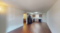This single-story unit in Lake Charles, Louisiana, offers a practical and functional layout across two bedrooms and one bathroom. The living area is spacious and open, featuring rich wood-look laminate flooring that extends throughout the main living spaces. A front-facing window allows natural light to fill the room, creating a bright and welcoming atmosphere.

The kitchen is positioned adjacent to the living area and is well-appointed with medium-toned wood cabinetry, light granite-style countertops, and a full suite of black appliances including a refrigerator, electric range, and dishwasher. A window above the sink provides additional natural light to the workspace.

Both bedrooms are carpeted for comfort and include closets for storage. The bedrooms feature windows with blinds, allowing for natural light and privacy. The shared bathroom includes a vanity with granite-style countertops, a large mirror, wood-look flooring, and convenient access to both bedrooms. A separate closet within the bathroom provides additional storage. The overall design is clean and straightforward, offering a comfortable and functional living environment.