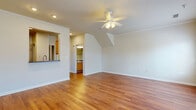 Located at 825 Beverley Dr in Charlottesville, Virginia, this well-appointed 2-bedroom, 2-bathroom single-floor home offers a thoughtfully designed layout that maximizes comfort and functionality. The spacious living room is an immediate standout, showcasing gleaming hardwood floors, crown molding, a ceiling fan with light fixture, and multiple windows that fill the space with abundant natural light and views of the surrounding neighborhood. A pass-through window connects the living area seamlessly to the kitchen, which is equipped with warm honey-toned wood cabinetry, dark countertops, a double-basin sink, and stainless steel appliances including a range and refrigerator. The bedrooms are carpeted for comfort and include ceiling fans and windows that invite natural light. The primary bedroom offers a generously sized footprint along with closet storage. The bathrooms feature clean white tiling, including a soaking tub in one bath. A dedicated in-unit laundry room with full-size washer and dryer hookups adds everyday convenience. With consistent hardwood flooring throughout the main living areas and a neutral color palette, this home presents a clean, cohesive, and inviting atmosphere throughout.