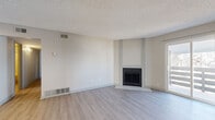 Located at 10225 E Girard Ave in Denver, Colorado, this single-floor residence offers a well-organized layout with a clean, neutral aesthetic throughout. The living room serves as the heart of the home, featuring light wood-style flooring, a textured ceiling, and a fireplace as a standout focal point. Sliding glass doors lead directly to a private balcony, filling the space with natural light and providing an easy indoor-outdoor connection. The kitchen is thoughtfully designed with a peninsula counter, stainless steel appliances including a gas range and refrigerator, sleek cabinetry, and a ventilation hood — all complemented by the same light flooring that flows throughout the main living areas. The bedrooms offer a comfortable, quiet retreat with plush carpeting, neutral walls, and a textured ceiling. One bedroom includes a dedicated closet, while a window invites natural light into another. The bathrooms feature clean white tile surrounds and light wood-style flooring, maintaining the consistent, modern palette found throughout the residence. Connecting hallways are bright and efficiently designed. Overall, the space presents a fresh, updated interior with a cohesive light-toned design well-suited for comfortable everyday living in Denver.