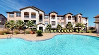This outdoor pool amenity space offers a resort-style experience designed for relaxation and recreation. At its centerpiece is a generously sized, crystal-clear swimming pool with stainless steel entry railings, accompanied by a separate spa for added comfort. The expansive surrounding sundeck is finished in a smooth concrete surface and is well-furnished with an array of lounge chairs and shaded umbrella seating, providing ample space for sunbathing and socializing under open skies.

The area is framed by mature trees and carefully maintained landscaping, including palm trees and native plantings that enhance the resort-like ambiance. A paved walkway connects the pool deck to the surrounding grounds, which feature manicured lawn areas and decorative fencing that define the space while maintaining open sightlines.

A dedicated pool house structure serves as the entry and support facility for the pool area. It features stucco and stone exterior finishes consistent with the surrounding architecture, large glass doors and windows that offer views directly onto the pool deck, and wall-mounted lighting fixtures. Posted pool rules signage and nearby seating indicate a well-managed and community-focused amenity. The multi-story residential buildings surrounding the pool provide a sense of enclosure while allowing abundant natural light to fill the space throughout the day.