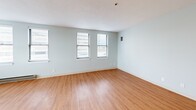 Located at 130 Dartmouth St in Boston's Back Bay neighborhood, this one-bedroom, one-bathroom residence offers a functional and well-designed layout across a single floor. Warm hardwood-style flooring runs continuously throughout the space, creating a cohesive and inviting atmosphere.

The living room is bright and open, with multiple windows fitted with blinds that allow for ample natural light. A baseboard heating unit ensures year-round comfort. The space flows naturally into the rest of the unit, providing a practical and connected layout.

The galley-style kitchen is efficiently organized, featuring light wood cabinetry, dark speckled countertops, an integrated sink, and a stainless steel refrigerator. Upper and lower cabinetry provide generous storage throughout.

The spacious primary bedroom comfortably accommodates furnishings and includes a large closet with paneled bi-fold doors, offering excellent storage. The room benefits from natural light through its window. An additional closet elsewhere in the unit further enhances storage options.

The bathroom is clean and well-appointed, featuring a light wood vanity with a white countertop, a mirrored medicine cabinet with overhead lighting, and hardwood-style flooring that maintains design continuity. The textured ceilings and soft neutral wall tones throughout contribute to a calm, understated aesthetic.