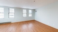 Located at 130 Dartmouth St in Boston's Back Bay neighborhood, this one-bedroom, one-bathroom residence offers a functional and well-designed layout across a single floor. Warm hardwood-style flooring runs continuously throughout the space, creating a cohesive and inviting atmosphere.

The living room is bright and open, with multiple windows fitted with blinds that allow for ample natural light. A baseboard heating unit ensures year-round comfort. The space flows naturally into the rest of the unit, providing a practical and connected layout.

The galley-style kitchen is efficiently organized, featuring light wood cabinetry, dark speckled countertops, an integrated sink, and a stainless steel refrigerator. Upper and lower cabinetry provide generous storage throughout.

The spacious primary bedroom comfortably accommodates furnishings and includes a large closet with paneled bi-fold doors, offering excellent storage. The room benefits from natural light through its window. An additional closet elsewhere in the unit further enhances storage options.

The bathroom is clean and well-appointed, featuring a light wood vanity with a white countertop, a mirrored medicine cabinet with overhead lighting, and hardwood-style flooring that maintains design continuity. The textured ceilings and soft neutral wall tones throughout contribute to a calm, understated aesthetic.