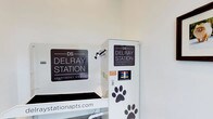 Delray Station Apartment Homes is a thoughtfully designed residential community that goes beyond the basics to cater to the needs of its residents and their pets. The space showcases a dedicated pet care station, a standout amenity that speaks to the community's pet-friendly philosophy. The station is clearly branded with the Delray Station logo and features paw print accents, giving it a welcoming and playful character. Designed for practicality, the pet station is equipped with the tools and fixtures needed to keep furry companions clean and well-groomed. The bright, clean, white interior provides a crisp and functional environment, ensuring ease of use and maintenance. The single-floor layout of this amenity space makes it easily accessible to all residents. This pet care area reflects the broader commitment of Delray Station Apartment Homes to providing convenient, lifestyle-enhancing amenities. For more information, residents and prospective tenants can visit stationapts.com, as displayed prominently within the space.