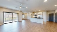 Located at 5 Ledge Dr in Schenectady, NY, this well-appointed 2-bedroom, 2-bathroom single-floor home offers a thoughtfully designed open-concept layout with modern finishes throughout. The combined kitchen and living area forms the heart of the home, featuring luxury vinyl plank flooring, recessed lighting, and a ceiling fan. The kitchen is a standout, showcasing white shaker cabinetry, dark granite countertops, a large center island with pendant lighting, a tile backsplash, and a full suite of stainless steel appliances. Sliding glass doors lead to a private balcony, flooding the space with natural light and providing outdoor access. Both bedrooms are comfortably sized, with plush carpeting, natural light from large windows with blinds, and neutral tones. The primary bedroom includes a walk-in closet outfitted with built-in shelving and hanging rods for ample storage. The bathroom features elegant herringbone tile flooring, a gray vanity with white countertop, and a glass-enclosed walk-in shower. The clean, neutral color palette and modern design elements create a bright, cohesive ambiance throughout the entire home.