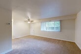 Located at 6507 Hil Mar Dr in District Heights, MD, this one-bedroom, one-bathroom residence offers a well-organized single-floor layout with a practical and comfortable design. The living room is a generous, open space featuring warm neutral-toned carpeting, a ceiling fan with light fixture, and a large window dressed with vertical blinds that invite ample natural light and outdoor views of surrounding greenery. The room's clean, simple lines create a versatile and welcoming atmosphere. The kitchen is efficiently designed with warm wood-toned cabinetry, granite-style countertops, a stainless steel sink, a dishwasher, and a full-size refrigerator, all complemented by light wood-style flooring that adds a modern touch. The spacious primary bedroom features plush carpeting, a bright window overlooking the outdoors, and a full-panel closet providing generous storage. A hallway connects the rooms, with additional closet space enhancing overall storage capacity. Throughout the residence, neutral cream-toned walls create a bright, cohesive ambiance. This unit offers a functional and comfortable living experience in a convenient District Heights location.