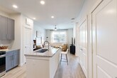 Located at 1505 Oliver St in Houston's vibrant Washington Avenue corridor, this well-designed one-bedroom, one-bathroom residence offers a thoughtful layout across a single floor. The open-concept kitchen, dining, and living area forms the heart of the home, bathed in natural light from large windows and finished with light wood-look flooring throughout. The kitchen is a standout feature, showcasing grey shaker-style cabinetry, granite countertops, a peninsula island with an undermount stainless steel sink, subway tile backsplash, and a full suite of stainless steel appliances including a French-door refrigerator. A pantry and additional closet storage add practical functionality. The combined dining and living area flows seamlessly from the kitchen, anchored by a ceiling fan and windows overlooking the exterior. The bedroom offers a comfortable retreat with a ceiling fan, large window with natural light, and access to a generous walk-in closet equipped with wire shelving and wood-look flooring. The bathroom features grey cabinetry, granite countertops, a dual-mirror vanity setup, and a sleek marble-tiled shower. A dedicated laundry area, entrance hallway, and multiple closets round out the well-appointed layout, making this home both functional and stylish.