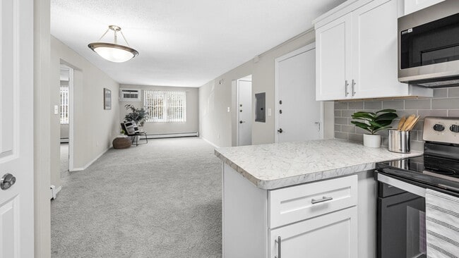 Some kitchens boast a charming breakfast bar, perfect for leisurely mornings. - Sugarloaf Estates Apartments