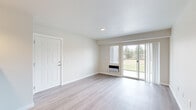 This 2-bedroom, 1-bathroom unit at 4719 W Garden Springs Rd in Spokane, WA offers a well-organized single-level layout designed for comfortable everyday living. The bright and open living room features light wood-style flooring, recessed lighting, and a sliding glass door that opens to a private balcony overlooking lush greenery, allowing natural light to fill the space. A wall unit provides in-room climate control for added convenience.

The galley-style kitchen is thoughtfully appointed with rich dark wood cabinetry, light granite-style countertops, a stainless steel sink, and black appliances including a range and over-the-range microwave. A pendant light adds a touch of character to the space. The adjacent dining area flows naturally from the kitchen.

Both bedrooms are carpeted and feature neutral tones, with windows that frame views of the surrounding trees, creating a calm and restful atmosphere. The primary bedroom offers a generous footprint with a closet for storage. The second bedroom is compact and versatile.

The full bathroom includes a dark wood vanity with a stone-style countertop, wood-style flooring, and a bathtub with shower. Clean white walls and neutral finishes are consistent throughout the unit, giving the space a fresh, move-in-ready feel.