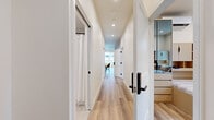 Located at 533 Glenrock Ave in Los Angeles, CA 90024, this modern single-floor unit offers four bedrooms and two bathrooms within a thoughtfully designed layout. The open-concept kitchen is outfitted with light wood cabinetry, white quartz countertops, a stainless steel appliance suite, and a textured tile backsplash, with a peninsula island that provides additional prep and seating space. Light wood flooring flows throughout, lending a clean, cohesive feel to the entire home. The living room is bright and welcoming, with large windows overlooking neighborhood greenery and ample space for comfortable seating arrangements. Each bedroom is designed with simplicity and function in mind, featuring natural light from well-placed windows, built-in headboard storage in select rooms, and individual wall-mounted climate control units. The bedrooms vary in layout, with some accommodating two twin beds, making the space well-suited for shared living. The two bathrooms are finished in neutral tones with terrazzo-style flooring, wall-mounted vanities with illuminated mirrors, and bathtub-shower combinations featuring textured tile surrounds. The overall aesthetic is clean, contemporary, and practical, making this Westwood-adjacent home an ideal option for those connected to UCLA or the surrounding Los Angeles community.
