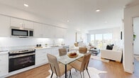 Located at 1011-1013 Everett St in the vibrant Echo Park neighborhood of Los Angeles, this thoughtfully designed one-bedroom, one-bathroom unit offers a clean, modern aesthetic throughout. The open-concept layout seamlessly connects the kitchen, dining, and living areas, creating a bright and functional living space bathed in natural light. Wide-plank wood-style flooring runs throughout, adding warmth to the crisp white palette.

The kitchen is outfitted with sleek white cabinetry extending to the ceiling, white quartz countertops, and a full suite of stainless steel appliances, including a refrigerator, range, microwave, and dishwasher. A dedicated dining area with a glass-top table sits adjacent, ideal for everyday meals or entertaining.

The living room opens directly onto a private balcony through a sliding glass door, offering treetop and neighborhood views of Los Angeles. The bedroom is comfortably sized, featuring a large window with outdoor views, and includes a closet with built-in shelving. The bathroom features warm wood-toned cabinetry, a single vanity with a wide mirror, and a full tub-shower combination with marble-style tile surround. Recessed lighting throughout completes the polished, contemporary feel of this well-appointed unit.