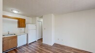 Located at 2509 Avent Ferry Rd in Raleigh, NC, this one-bedroom, one-bathroom unit offers a practical and well-organized layout across a single floor. Wood-style plank flooring runs throughout the entire unit, complemented by white walls and textured ceilings that give the space a clean, consistent aesthetic.

The open-concept kitchen and living area forms the heart of the unit. The kitchen is equipped with warm wood cabinetry, a white refrigerator, dishwasher, and a sink with under-cabinet storage. A pantry provides additional storage convenient to the kitchen.

The living area flows naturally from the kitchen and features a sliding glass door that opens to a private balcony, allowing natural light to fill the room and providing outdoor views of the surrounding area.

The bedroom is a well-proportioned room with a window that brings in natural light and an outlook to the outdoors. It includes a sliding-door closet for storage, and the unit overall benefits from three closets in total, offering generous storage throughout. A wall-mounted HVAC unit ensures climate control comfort.

The bathroom is clean and functional, featuring a full soaking tub with shower. A hallway connects the main living spaces to the bedroom and bathroom, maintaining a clear and efficient flow throughout the unit.