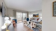 This contemporary 920 square foot apartment in Marietta, GA, offers a blend of style and functionality. The space features two bedrooms, including a primary bedroom of 170 square feet, and one bathroom. The open-concept design seamlessly integrates the living and dining areas, creating a spacious feel.

The kitchen is a highlight, boasting sleek white cabinetry, stainless steel appliances, and a subway tile backsplash. It opens to a dining area adorned with modern furnishings and eye-catching artwork. The living room is bathed in natural light from large sliding glass doors leading to a private balcony, offering views of the surrounding area.

Both bedrooms are well-appointed, with the primary bedroom featuring ample closet space and room for a king-sized bed. The bathroom, while not pictured, likely continues the modern aesthetic found throughout the home.

Additional amenities include in-unit laundry facilities with full-sized washer and dryer, hardwood-style flooring throughout, and carefully curated decor that adds pops of color to the neutral palette. The apartment's design emphasizes clean lines and a minimalist approach, creating a sophisticated urban oasis.

Located at 2703 Delk Rd, this apartment offers the perfect balance of style, comfort, and convenience in the heart of Marietta.