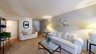 Located at 4901 Wynnewood Rd in Harrisburg, PA, this two-story home offers a well-organized layout split evenly across two floors. The main level features a comfortable living room with soft carpeting, neutral gray-toned walls, and a large window that allows natural light to fill the space. A staircase with a classic railing connects to the upper level. Adjacent to the living room is a dedicated dining area with carpeted flooring and a window with decorative valance. The kitchen is efficiently designed with warm oak cabinetry, granite-style countertops, tile flooring, a double sink, dishwasher, and a gas range with overhead ventilation. A full bathroom on this level features blue tiled walls and a tub-shower combination. Upstairs, the generously sized primary bedroom offers carpeted floors, ample wall space, and access to a dedicated walk-in closet with built-in shelving rods. A second carpeted bedroom includes a sliding-door closet and is well-suited as a guest room or home office. Both floors are connected by a second staircase, providing easy circulation throughout. The overall ambiance is clean, functional, and move-in ready, with a practical and efficient floor plan suitable for a variety of lifestyles.