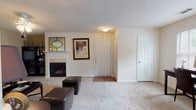 Located at 2010 Roswell Rd in Marietta, Georgia, this single-floor residence offers a well-organized layout with distinct living, dining, sleeping, and kitchen areas connected by a central hallway. The living room serves as the heart of the home, featuring a tiled fireplace with a classic white mantle, soft carpeting, and a textured ceiling that adds subtle depth. An open transition leads into the dining area, which benefits from multiple windows that invite generous natural light and offer views of the surrounding greenery. Adjacent to the dining space is a dedicated area suitable for a home office, further enhancing the functional versatility of the floor plan. The kitchen is equipped with ample light-toned cabinetry, white countertops, a double sink, and tile flooring that extends through the main traffic areas. A hallway connects the kitchen to the bedrooms, each of which features plush carpeting, natural light from well-positioned windows, and a textured ceiling with ceiling fan fixtures. Two full bathrooms, each with a tub-shower combination and tile flooring, provide practical convenience. Throughout the residence, a neutral color palette, consistent finishes, and a logical flow between spaces create a cohesive and comfortable living environment.