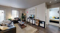 This contemporary 900 square foot apartment in Morgantown, WV, offers a well-designed living space with four bedrooms and two bathrooms. The single-floor layout maximizes functionality, featuring an open-concept kitchen and living area. The kitchen boasts white cabinetry, modern appliances, and a convenient breakfast bar that overlooks the living room.

Each bedroom is thoughtfully appointed, with the primary bedroom spanning 100 square feet. The rooms are bright and airy, with large windows allowing natural light to flood the space. Stylish ceiling fans in the bedrooms provide both comfort and visual appeal.

The bathrooms are modern and sleek, featuring wood-look flooring, ample counter space, and contemporary fixtures. The apartment also includes an in-unit laundry area with a stacked washer and dryer, adding convenience for residents.

Throughout the apartment, neutral tones are accented with pops of color and artistic elements, creating a cohesive and inviting atmosphere. The living area is adorned with eye-catching wall art and comfortable furnishings, perfect for relaxation or entertaining.

Wood-look flooring runs throughout the common areas, while bedrooms feature plush carpeting. The overall design aesthetic is clean and contemporary, with a mix of modern and traditional elements that create a welcoming home environment.