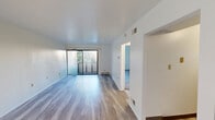 Located at 3429 Dawson St in Pittsburgh's Oakland neighborhood, this one-bedroom, one-bathroom unit offers a functional and well-appointed single-floor layout. The open living room is a standout, featuring light wood-style flooring that runs throughout the main living areas, clean white walls, and a large sliding glass door that floods the space with natural light and opens to a private balcony with outdoor views. The layout connects seamlessly through hallways to the remaining rooms. The kitchen is equipped with warm honey-toned cabinetry, dark granite countertops, a stainless steel gas range with overhead exhaust, and a stainless steel sink — offering a practical and attractive workspace. The bedroom is a comfortable, well-sized retreat with a ceiling fan with light fixture and soft carpeting underfoot, providing a cozy contrast to the hard-surface flooring in the living areas. Additional carpeted spaces offer flexible utility. The bathroom features a full tub-shower combo with a white surround, a wood-toned vanity with dark granite countertop, and a textured ceiling. Throughout, the unit maintains a clean, neutral aesthetic that is move-in ready.