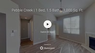 This 790 square foot apartment in Indianapolis offers a well-designed living space with two bedrooms and two bathrooms. The single-floor layout maximizes efficiency, with the primary bedroom boasting a generous 160 square feet. The modern kitchen is equipped with black appliances, including a refrigerator and built-in microwave, complemented by two-toned cabinetry and a practical breakfast bar.

The living area features vaulted ceilings, enhancing the sense of space, and is adorned with recessed lighting. Flooring varies throughout, with wood-look laminate in the main living areas and plush carpeting in the bedrooms. An interesting architectural detail is the arched entryway leading to one of the rooms, adding character to the space.

Both bathrooms are functional, with one showcasing a combination tub-shower unit. The apartment's neutral color palette, primarily in shades of grey and white, creates a blank canvas for personalization. Large windows in the bedrooms and living area allow for ample natural light, while horizontal blinds offer privacy control.

The property at 2265 Rippling Way includes additional amenities such as a hallway and closet space, ensuring practical storage solutions. Overall, this apartment provides a comfortable and modern living environment, ideal for those seeking a compact yet well-appointed home in Indianapolis.