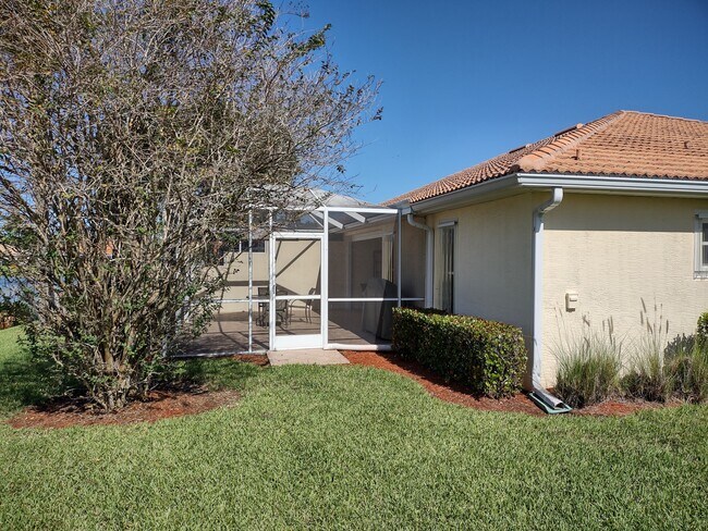 Rear with enclosed screen room - 13819 Lily Pad Cir