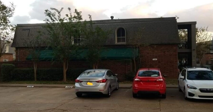 Street view and two number assigned parking spaces. - 4503 Heyman Ln