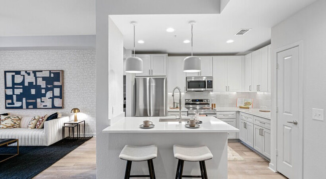 White Shaker Cabinetry with Designer Hardware and Tile Backsplash - Cortland Uptown Altamonte