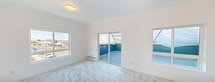 This contemporary 760 square foot apartment in Moses Lake, WA, offers a harmonious blend of style and functionality. The space boasts a single bedroom spanning 240 square feet, complemented by one bathroom. The apartment's most striking feature is its stunning marble-effect flooring, which flows seamlessly throughout, creating a sense of luxury and continuity.

Large windows dominate the living areas, flooding the space with natural light and offering views of the surrounding neighborhood. A private balcony, accessible through sliding glass doors, extends the living space outdoors, providing a perfect spot for relaxation or al fresco dining.

The open-concept layout seamlessly integrates the living room, dining area, and kitchen, ideal for modern living and entertaining. The kitchen is a chef's delight, featuring sleek white cabinetry, stainless steel appliances, and ample counter space. A built-in microwave and dishwasher add convenience to this well-appointed culinary space.

The bedroom is generously sized and includes a large closet with sliding doors for optimal storage. The bathroom continues the apartment's modern aesthetic with clean lines and bright, white fixtures. Throughout the apartment, recessed lighting and climate control systems ensure comfort and ambiance.

This turnkey apartment combines contemporary design with practical amenities, offering a perfect urban retreat in the heart of Moses Lake.