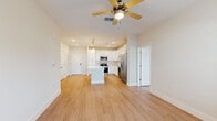 Located at 295 Royal Tern Cir in Rockledge, Florida, this well-designed 2-bedroom, 2-bathroom single-story home offers a bright, open-concept layout with a clean, modern aesthetic. Light wood-style flooring flows seamlessly throughout the entire home, lending a cohesive and airy feel to every room.

The kitchen is a standout feature, showcasing crisp white shaker cabinetry, white quartz countertops, a classic subway tile backsplash, and a full suite of stainless steel appliances including a range, microwave, dishwasher, and French door refrigerator. A central island with pendant lighting above provides additional prep space and casual seating, while recessed lighting ensures a well-lit cooking environment.

The open living area flows naturally from the kitchen and is equipped with a ceiling fan, offering views to a glass door that invites natural light. The spacious primary bedroom features a ceiling fan, neutral tones, and direct access to a walk-in closet outfitted with wire shelving for ample storage. The second bedroom is equally well-lit with dual windows and a ceiling fan overhead.

Both bathrooms are finished with white vanities featuring brushed nickel hardware, white countertops, and tile-surround tub-shower combinations. Clean lines and neutral finishes give the bathrooms a polished, functional character that complements the overall design of the home.