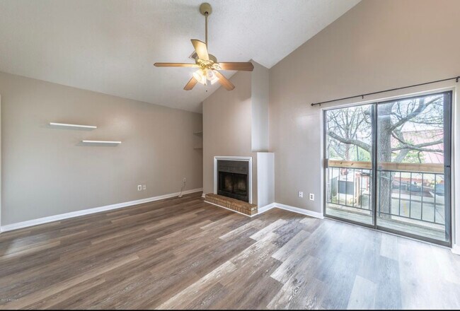 Living area with fireplace and balcony. - 913 St Landry St